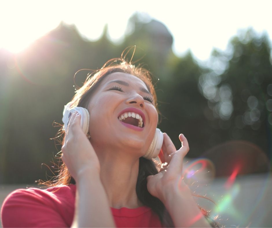 Femme en Rouge Chante avec Ecouteurs